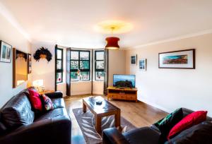 een woonkamer met twee banken en een tafel bij Mycosy on the river in Aberdeen
