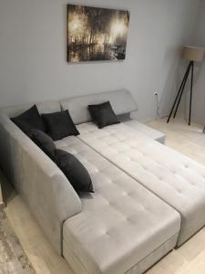 a large white couch in a living room at Acropolis brand new 1min from metro! in Athens