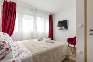 Postel nebo postele na pokoji v ubytování Apartments Cezar