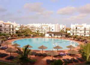 a large swimming pool with chairs and umbrellas at BCV Private 2 Bed Penthouse Apartment With Pool View Dunas Resort 1145 in Santa Maria