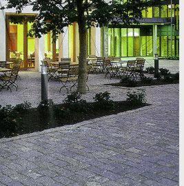 a group of benches and a tree in front of a building at Hotel Oberschwaebischer Hof in Schwendi