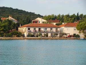 a house on the shore of a body of water at Trim Rooms and Apartments in Lovište