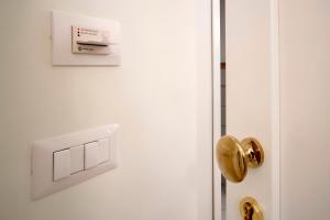 a white door with a gold door knob at Rosa Magra Guest House in Sorrento