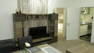 a living room with a flat screen tv on a wall at Muschelnische Strandhaferweg in Fehmarn