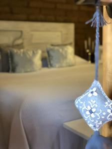 a blue glass with flowers on it hanging from a bed at Iztak - Xamikal in Zacatl&aacute;n