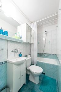 a bathroom with a toilet and a sink and a tub at Stare Miasto - Trębacka in Warsaw +12 photos