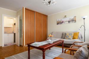 a living room with a couch and a table at Stare Miasto - Trębacka in Warsaw