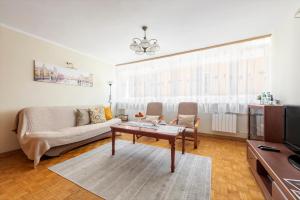 a living room with a couch and a table at Stare Miasto - Trębacka in Warsaw