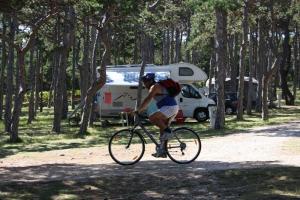 a person riding a bike in front of a trailer at Camping Planik in Ražanac