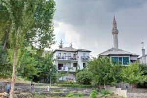 a building with a mosque in the background at Pansion Villa Nur in Mostar