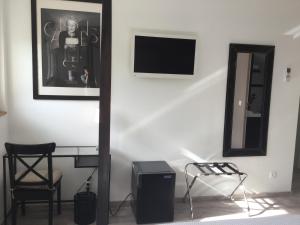 a room with a desk and a mirror and a chair at La Ressource in Fontguenand