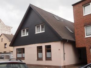 a house with a black roof at Fewo Sonnenschein in Bremerhaven