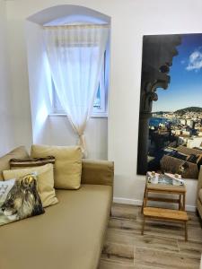 a living room with a couch and a window at Old town hesed in Split