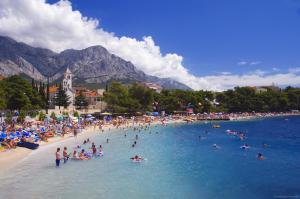 a group of people in the water at a beach at House Vera in Baška Voda