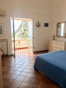 
a bedroom with a bed and a window at Little Flower in Positano
