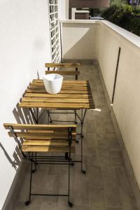a wooden table with two chairs and a bowl on it at L'ULIVO - home suite in Bari