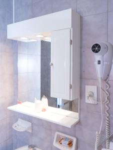 a bathroom with a white mirror and a toilet at Hotel Viña de Italia in Cordoba +58 photos
