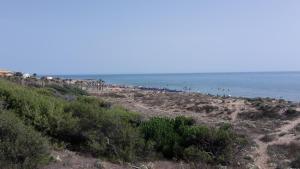 a group of people on a beach near the ocean at Villa Salvatore in San Leone
