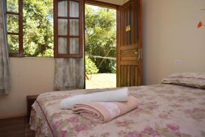 - une chambre avec un lit et une serviette dans l'établissement Iguassu Eco Hostel - IguassuEcoHostel - Eco Suítes, à Foz do Iguaçu