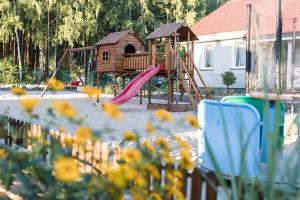 a playground with a slide and a play house at Rodzinna Przystan in Uście