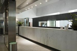 a lobby with a reception counter in a building at Vicenza Tiepolo Hotel in Vicenza