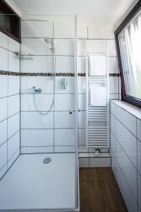 a bathroom with a shower with a glass door at Hotel Bisenius in Traben-Trarbach