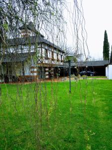 a building with a green yard with a light in the grass at Chalet de las Tejas in Rosario