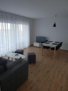 a living room with a couch and a table at Apartmani Marija in Baška Voda