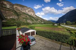 a car parked on a balcony with mountains in the background at Apartment AliS in Tønjum