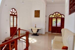 a living room with two doors and a table at Green Heritage Holiday Resort in Mahiyangana