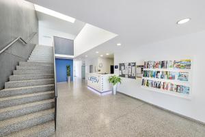 a staircase in a building with a book store at Hotel & Hostel Letov in Prague