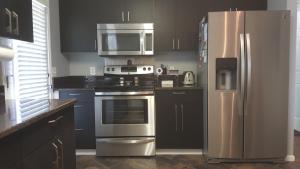 a kitchen with a stainless steel stove and refrigerator at Contemporary Paradise w/ Private Bathroom in Nashville +9 photos