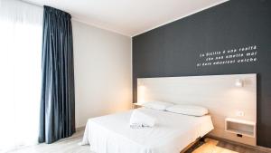 Posteľ alebo postele v izbe v ubytovaní Amada Hotel Siracusa