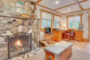 a fireplace in a living room with a stone wall at Eva's Cottage - Romancing the River in Washougal