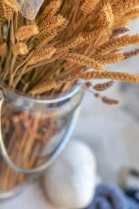 a close up of a vase filled with wheat at Paxos Fairytales Lovenest 2 in Gaios +11 photos