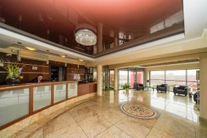 a lobby with a person standing in the middle of a building at Hotel Atena Wedding, Business & Spa in Ciechanów