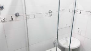 a bathroom with a toilet and a glass shower stall at Yves Hotel in Porto Velho +27 photos