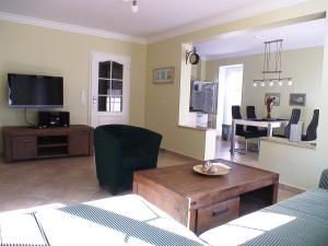 a living room with a couch and a tv and a table at Max und Moritz in Ostseebad Karlshagen