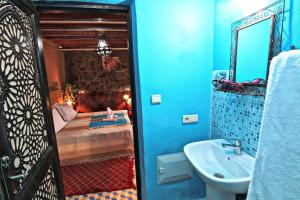 a bathroom with a bed and a sink and a mirror at Toubkal Garden in Imlil +37 photos