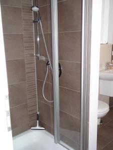 a shower with a glass door in a bathroom at Max und Moritz in Ostseebad Karlshagen +10 photos
