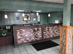 a restaurant with a counter with tiles on the wall at Lone Star Inn in Lubbock