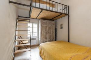 a bedroom with a bunk bed and a ladder at ** Lolile 1 ** in LʼIsle-sur-la-Sorgue