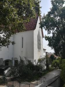 a white church with a clock on the side of it at Cozy Independent Room in Lisbon