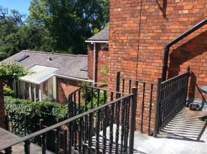 a brick house with a black fence next to a building at Highgate, Beverley/Hull in Beverley