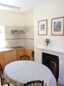 a kitchen with a table and a fireplace at Highgate, Beverley/Hull in Beverley