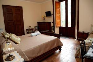 a bedroom with a bed and a window and a door at Agriturismo Sole di Sicilia in Randazzo