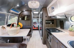 an rv kitchen with a stove and a counter top at Caravan Outpost in Ojai