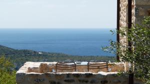 a group of chairs sitting on top of a stone wall at Antares Mani in Areopoli