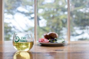a glass of wine sitting on a table with a plate of food at HI San Francisco Fisherman's Wharf Hostel in San Francisco