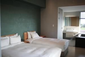 Postel nebo postele na pokoji v ubytování Y Resort Jeju